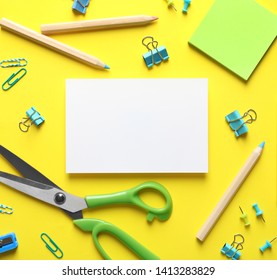 Flat lay composition with scissors and office supplies on color background. Space for text