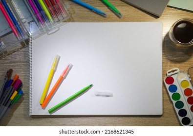 Flat Lay Composition With Sketchbook And Felt Tip Pens On Wooden Table