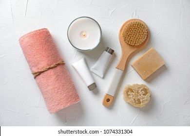 Flat Lay Composition With Spa Cosmetics And Towel On White Background