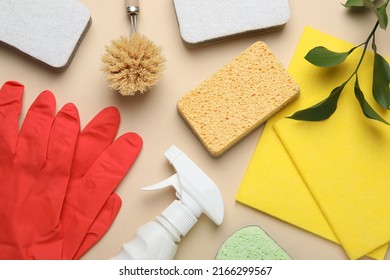 Flat lay composition with sponges and other cleaning supplies on beige background