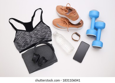 Flat Lay Composition Of Sports Equipment, Clothes On White Background. Fitness, Sport And Healthy Lifestyle Concept. Top View