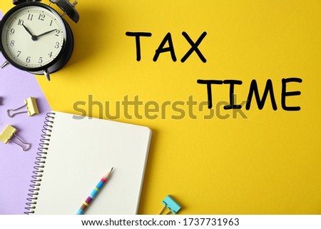 Flat lay composition with stationery on yellow background. Tax time