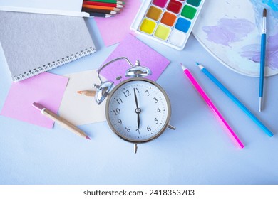 Flat lay composition with stationery, watercolor paints, brushes and colored pencils, palette,on a gray background. Back to school concept. - Powered by Shutterstock