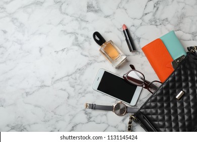 Flat lay composition with stylish bag, wallet and accessories on marble background