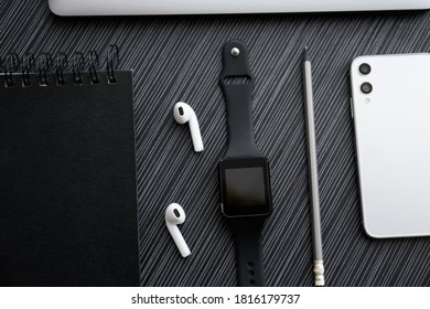 Flat lay composition with stylish smart watch on black table