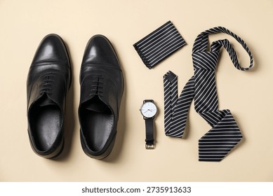 Flat lay composition with stylish tie and shoes on beige background