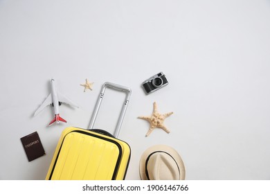 Flat lay composition with suitcase and travel accessories on grey background, space for text. Summer vacation - Shutterstock ID 1906146766
