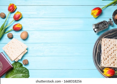 Flat lay composition with symbolic Pesach (Passover Seder) items on light blue wooden table, space for text