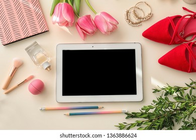 Flat lay composition with tablet and accessories on light background, space for design. Blogger's workplace