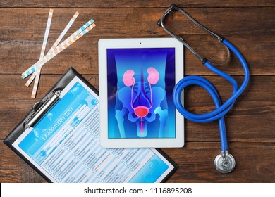 Flat Lay Composition With Tablet, Stethoscope And Test Form On Wooden Background. Urology Concept