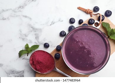 Flat Lay Composition With Tasty Acai Drink, Powder And Berries On Marble Table