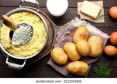 Flat lay composition with tasty mashed potatoes and ingredients on wooden table