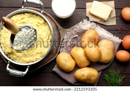 Flat lay composition with tasty mashed potatoes and ingredients on wooden table