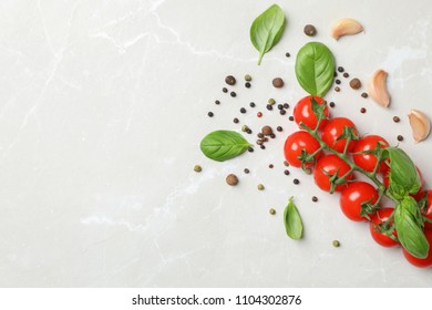 Flat lay composition with tomatoes, pepper and basil on light background - Shutterstock ID 1104302876