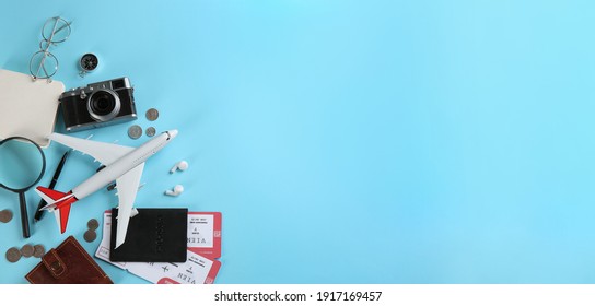 Flat Lay Composition With Toy Airplane And Travel Items On Light Blue Background. Space For Text