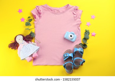 Flat lay composition with toy camera for little photographer on yellow background
