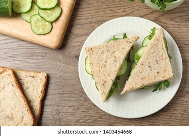 Flat Lay Composition With Traditional English Cucumber Sandwiches And Ingredients On Wooden Background