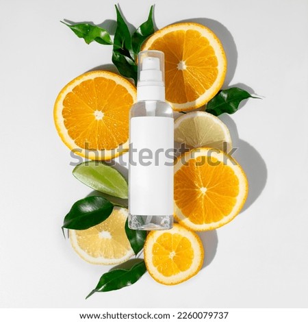 Flat lay composition with tube of cream, citrus fruits, green leaves on white background. Beauty concept natural vitamin cosmetic product, skin care, copyspace, top view