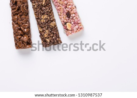 Flat lay composition with various cereal bars on color background, sugar, chocolate and muesli
