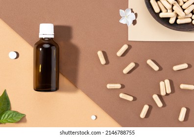 Flat lay composition of various dietary supplements on brown background. Vitamin complexes concept.
