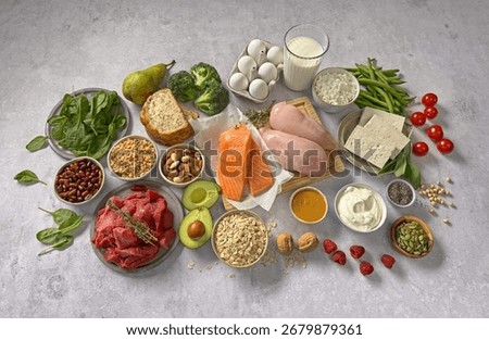 flat lay composition of various fresh protein diet products on grey background, top view. healthy eating, various fresh healthy products on grey table, top view. Healthy food clean eating selection