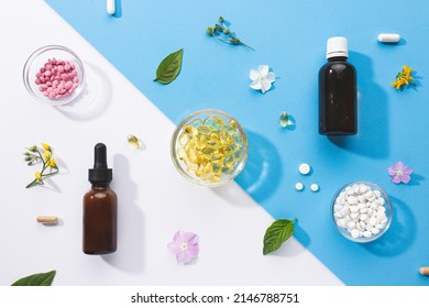 Flat lay composition of various vitamin capsules and dietary supplements on blue and white background. Vitamin complexes concept.