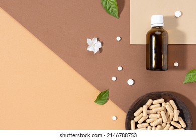 Flat lay composition of various vitamin capsules and dietary supplements on brown background with copy space. Vitamin complexes concept.