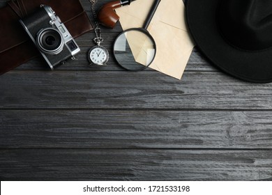 Flat lay composition with vintage detective items on grey wooden background, space for text