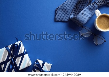 Flat lay composition with vintage gift boxes, coffee cup, necktie, glasses on dark blue background. Happy Fathers Day concept