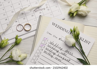 Flat lay composition with Wedding Checklist and Planner on white wooden table