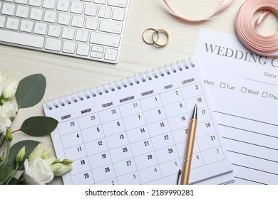 Flat lay composition with Wedding items and calendar on white wooden table