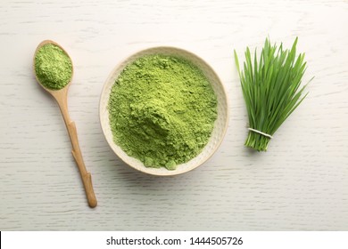 Flat Lay Composition With Wheat Grass Powder On White Wooden Table