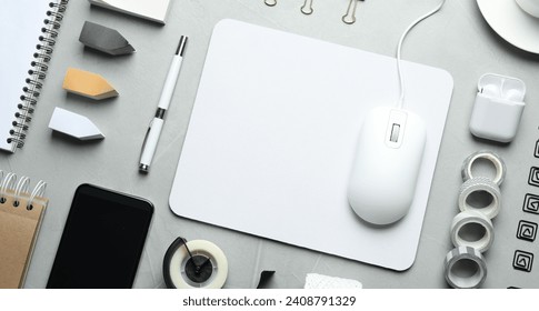 Flat lay composition with wired computer mouse and stationery on light grey table