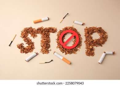Flat lay composition with word Stop made of dry tobacco and prohibition sign on beige background. Quitting smoking concept
