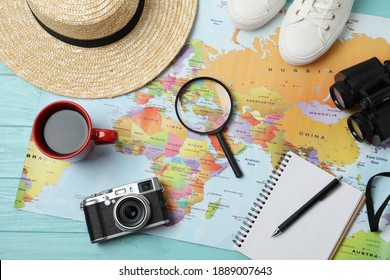 Flat lay composition with world map and different travel accessories on turquoise wooden table. Planning summer vacation trip - Powered by Shutterstock