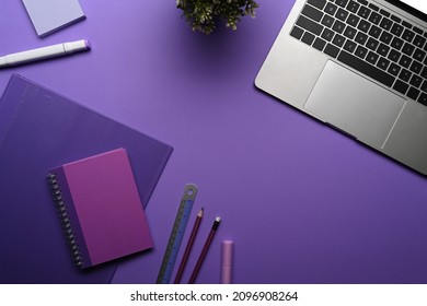 Flat lay computer laptop, potted plant and stationery on purple background. - Shutterstock ID 2096908264