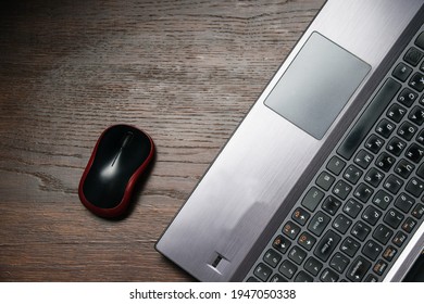 Flat lay, computer mouse and laptop on wooden table, copy space.