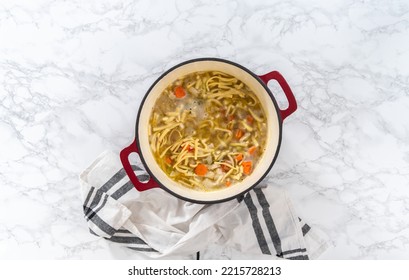 Flat Lay. Cooking Chicken Noodle Soup With Kluski Noodles In An Enameled Dutch Oven.