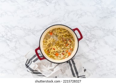 Flat Lay. Cooking Chicken Noodle Soup With Kluski Noodles In An Enameled Dutch Oven.