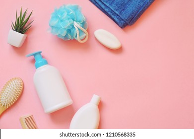 Flat lay cosmetic products photo. Shampoo bottle, liquid soap, blue sponge, terry towel, hair brush. Personal care concept