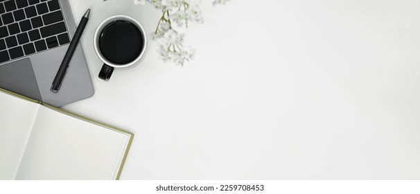 Flat lay cup of coffee, laptop and notebook on white office desk. Copy space for advertise text - Shutterstock ID 2259708453