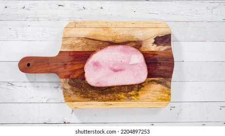 Flat Lay. Cutting Organic Honey Ham On A Wood Cutting Board.