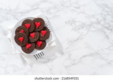 Flat Lay. Decorating Chocolate Cookies With Red Chocolate Hearts.