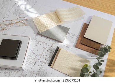 Flat lay design of creative interior design moodboard composition with samples materials like wood, textile, stone and black switch on blueprint background - Shutterstock ID 2136873131