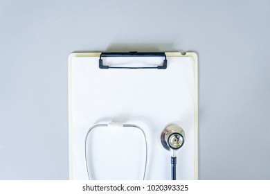 Flat Lay Design Of Stethoscope And Blank Clipboard Pad With For Medical Concept. Top View.