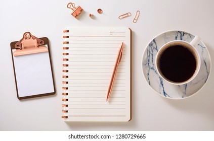 Flat Lay Desk With Notebook, Clipboard, Coffee Cup And Pen, Rose Gold Accessories, Warm Tone