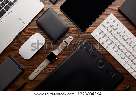 flat lay with different devices on wooden workplace