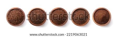Flat lay of Different types of grinds coffee in wooden bowl isolated on white background. Clipping path.