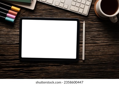 Flat lay digital tablet with blank screen, coffee cup and stationery on wood table. Modern workplace. - Shutterstock ID 2358600447