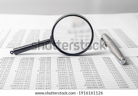 Flat lay of documents for accounting report of cash flow and pen